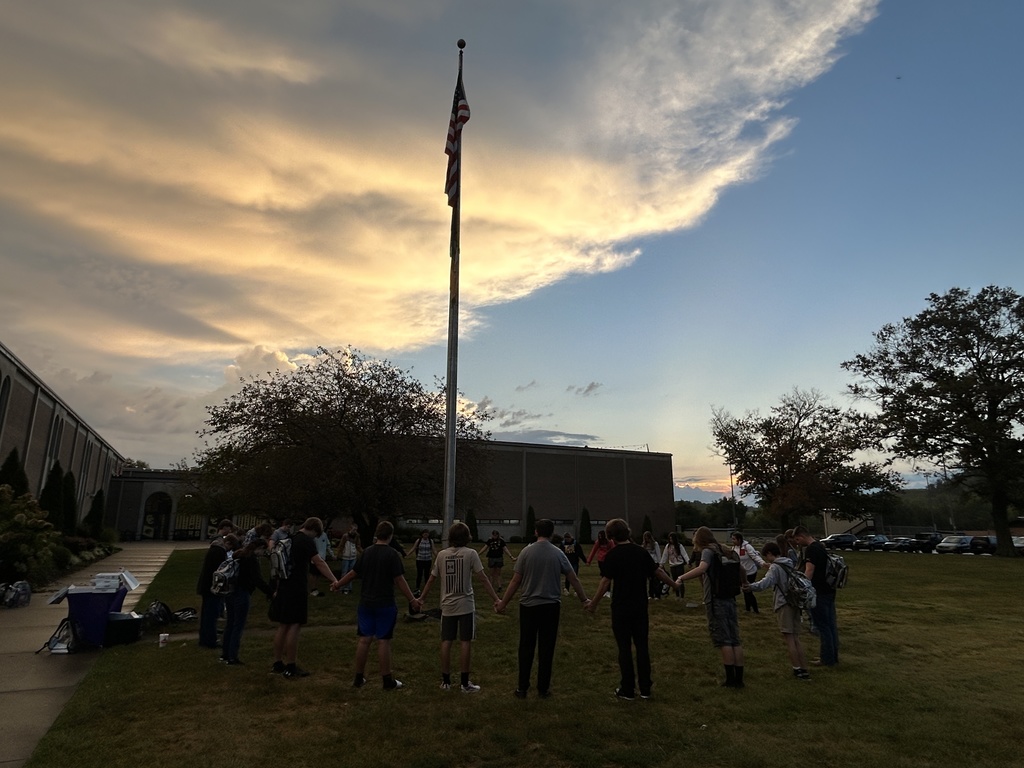 Students praying at the flag pole